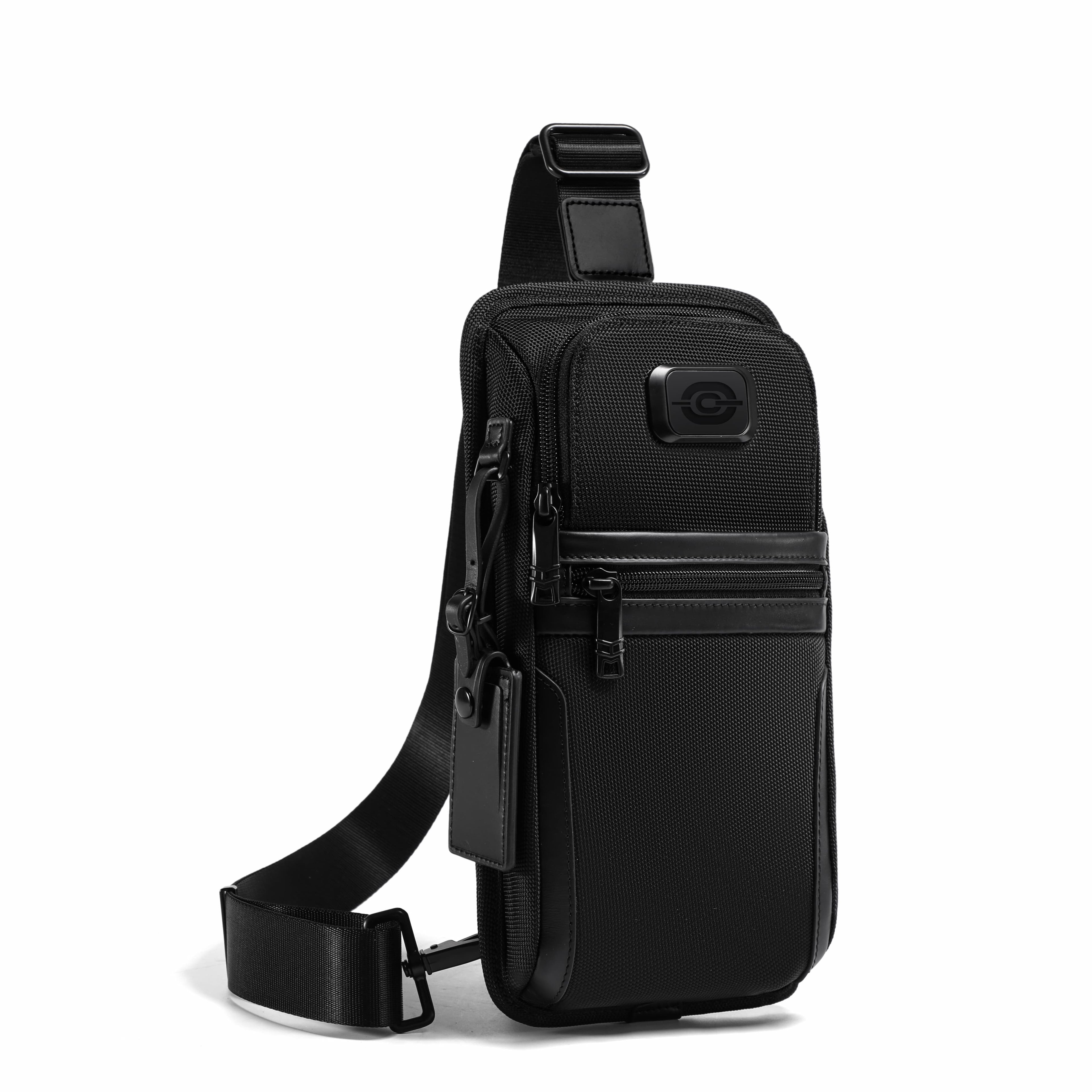 A black sling backpack with a single shoulder strap, multiple zippered pockets, and a small circular logo patch on the front, shown on a plain white background.