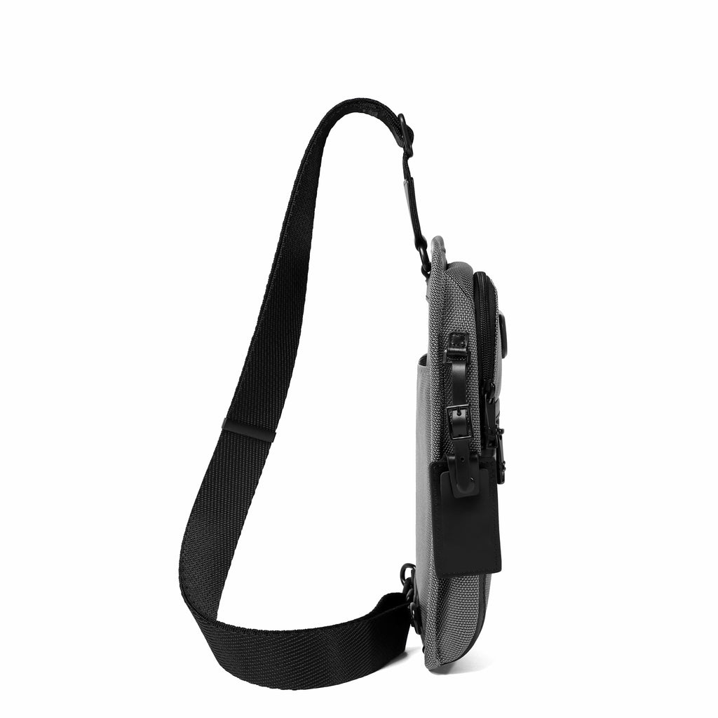 A side profile view of a gray and black crossbody sling bag with a black adjustable strap, shown against a solid white background.
