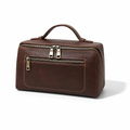 A dark brown faux-leather travel toiletry bag with a top handle, a front zippered pocket, and a top zip closure, shown on a white background with a soft shadow.