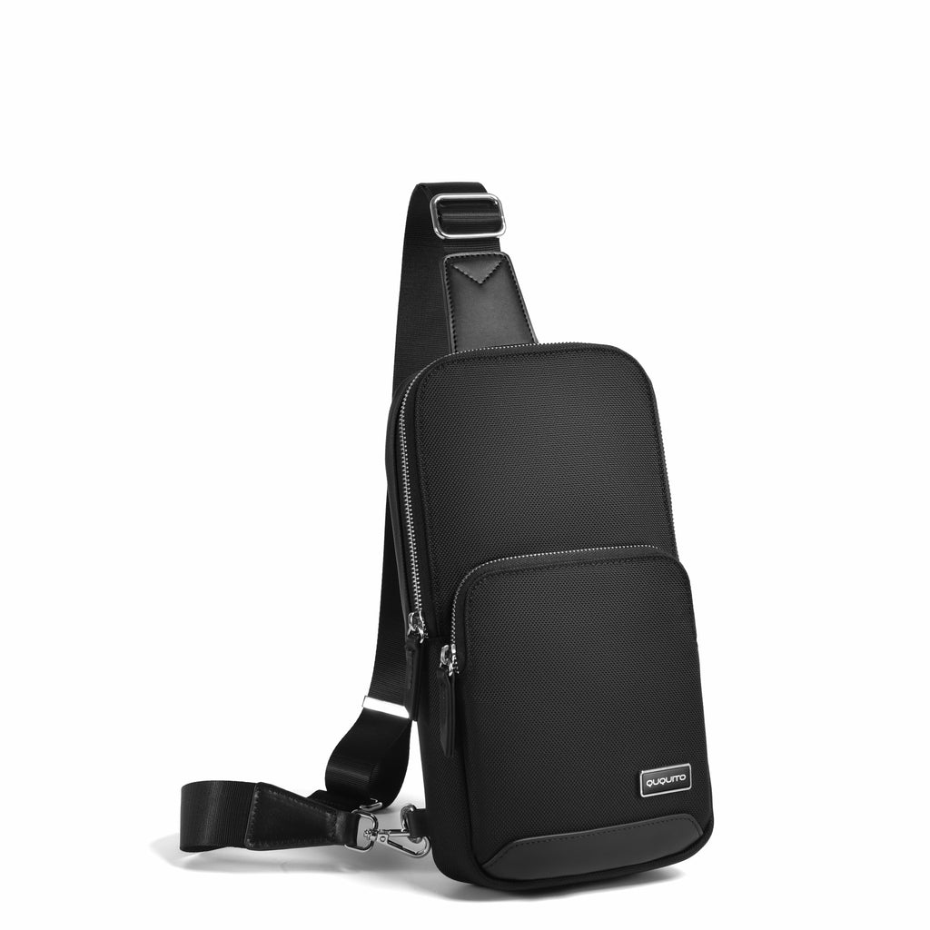 A black nylon sling bag with an adjustable shoulder strap, shown from a three-quarters angle on a clean white background.
