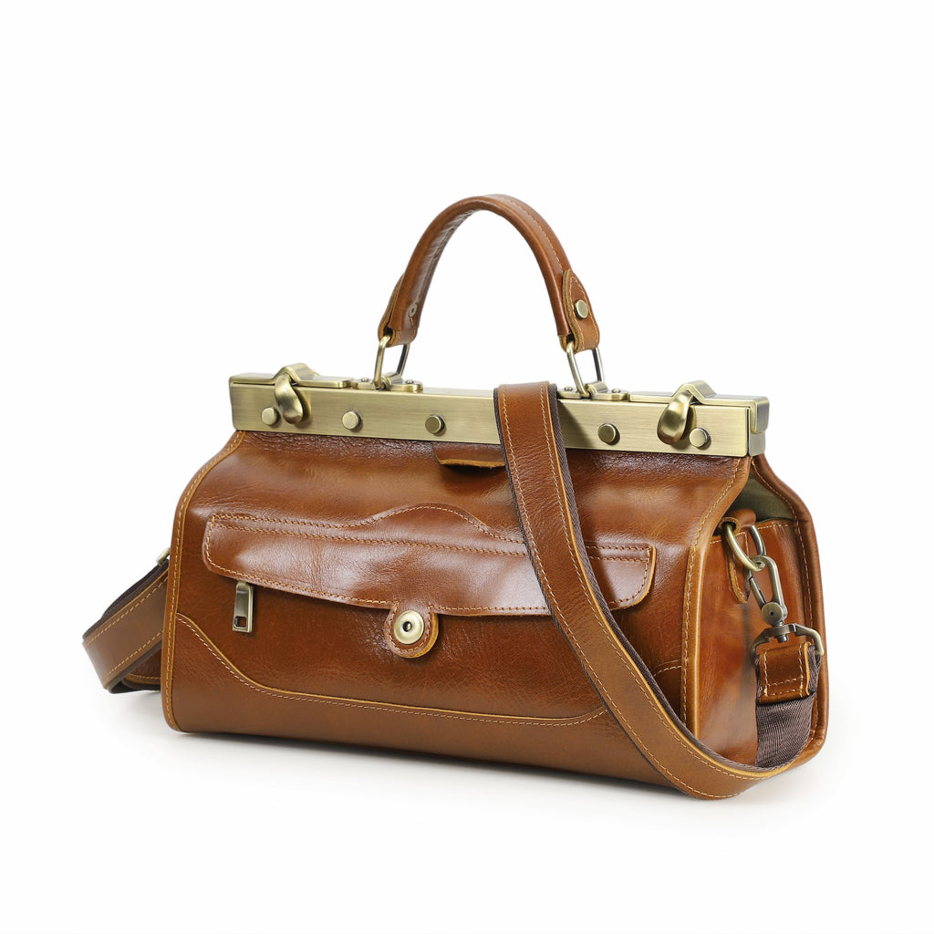 Brown leather handbag with gold accents on a white background