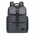 A dark gray and black backpack with a front flap pocket, vertical compression strap, and side pockets, shown against a plain white background.