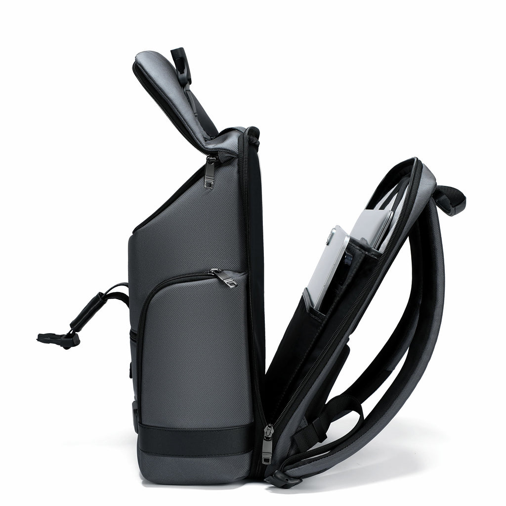 A black and dark gray convertible laptop backpack shown in a side profile view with its top lid open and the side pocket folded out to reveal a laptop inside, set against a plain white background.