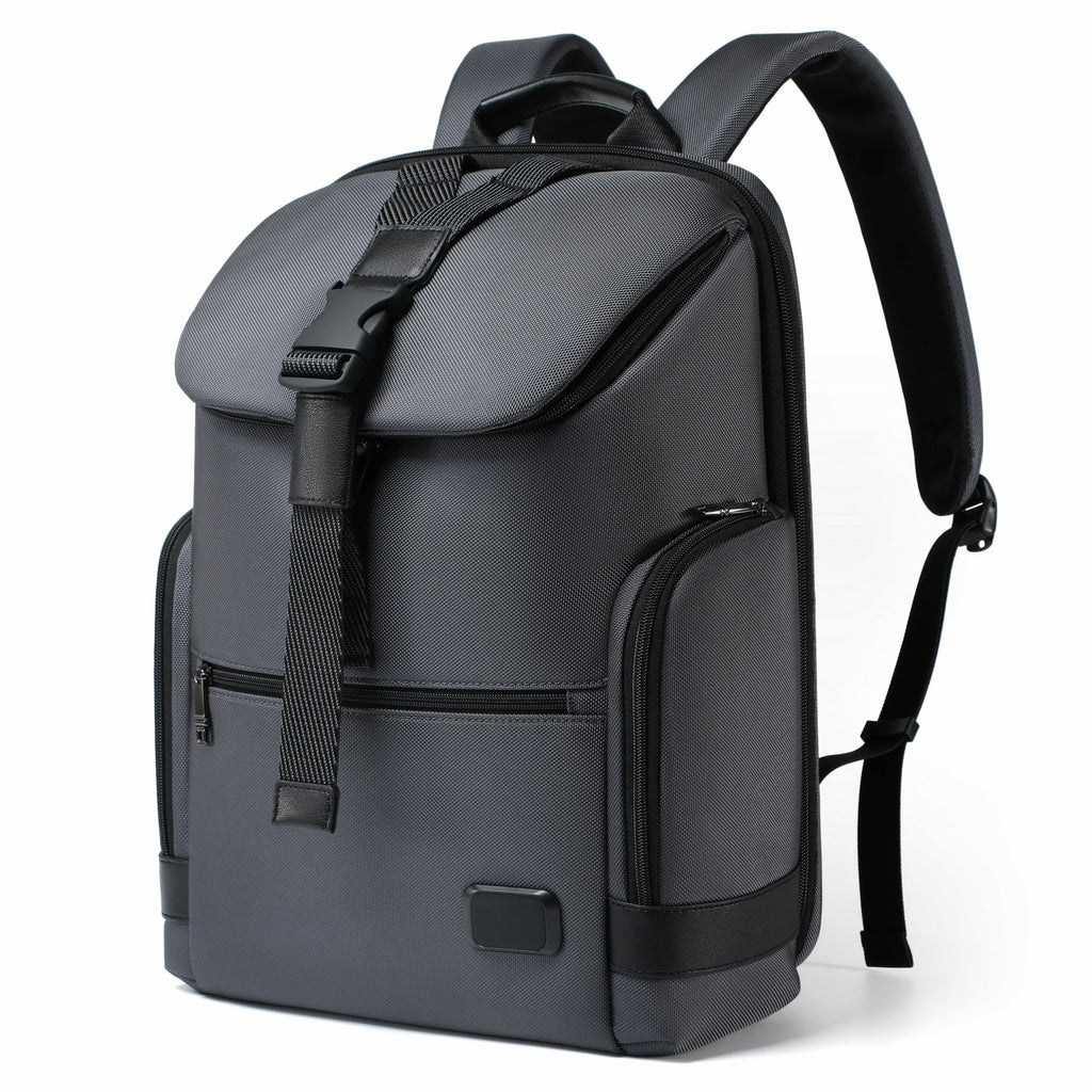 A dark gray and black backpack with a top flap, front zippered pocket, and padded shoulder straps, shown on a clean white background.