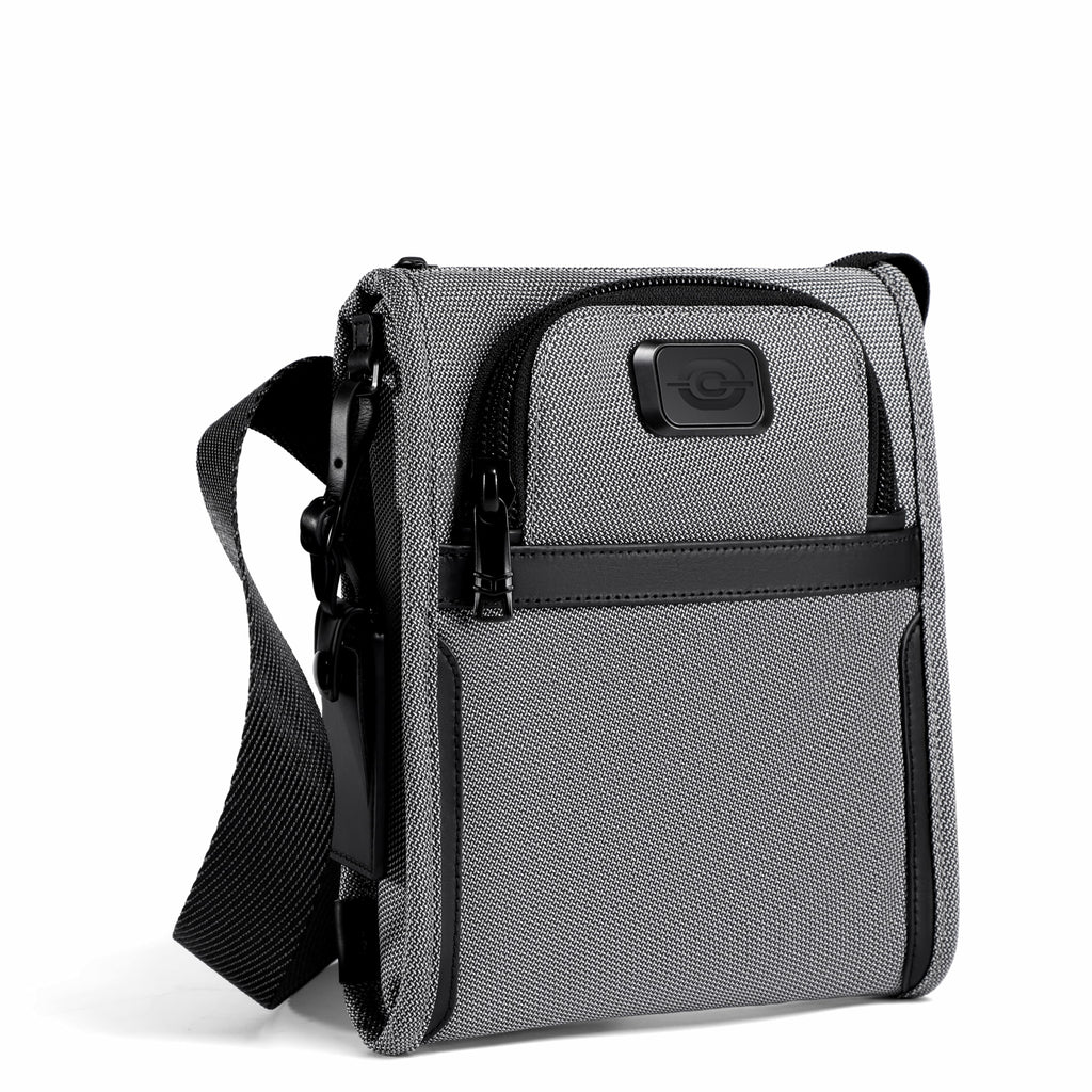 A gray and black crossbody phone bag with a textured front pocket, a front zippered compartment, and a black adjustable shoulder strap, shown on a white background.