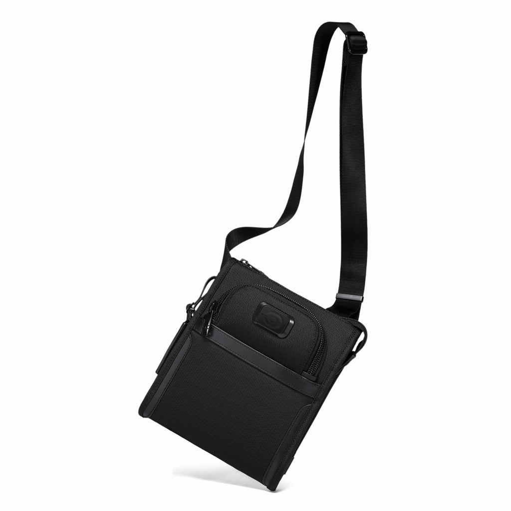 A black nylon crossbody bag with a long adjustable shoulder strap, shown at an angle on a solid white background.