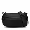 A black nylon crossbody bag with an adjustable shoulder strap and zippered compartments, shown on a clean white background.