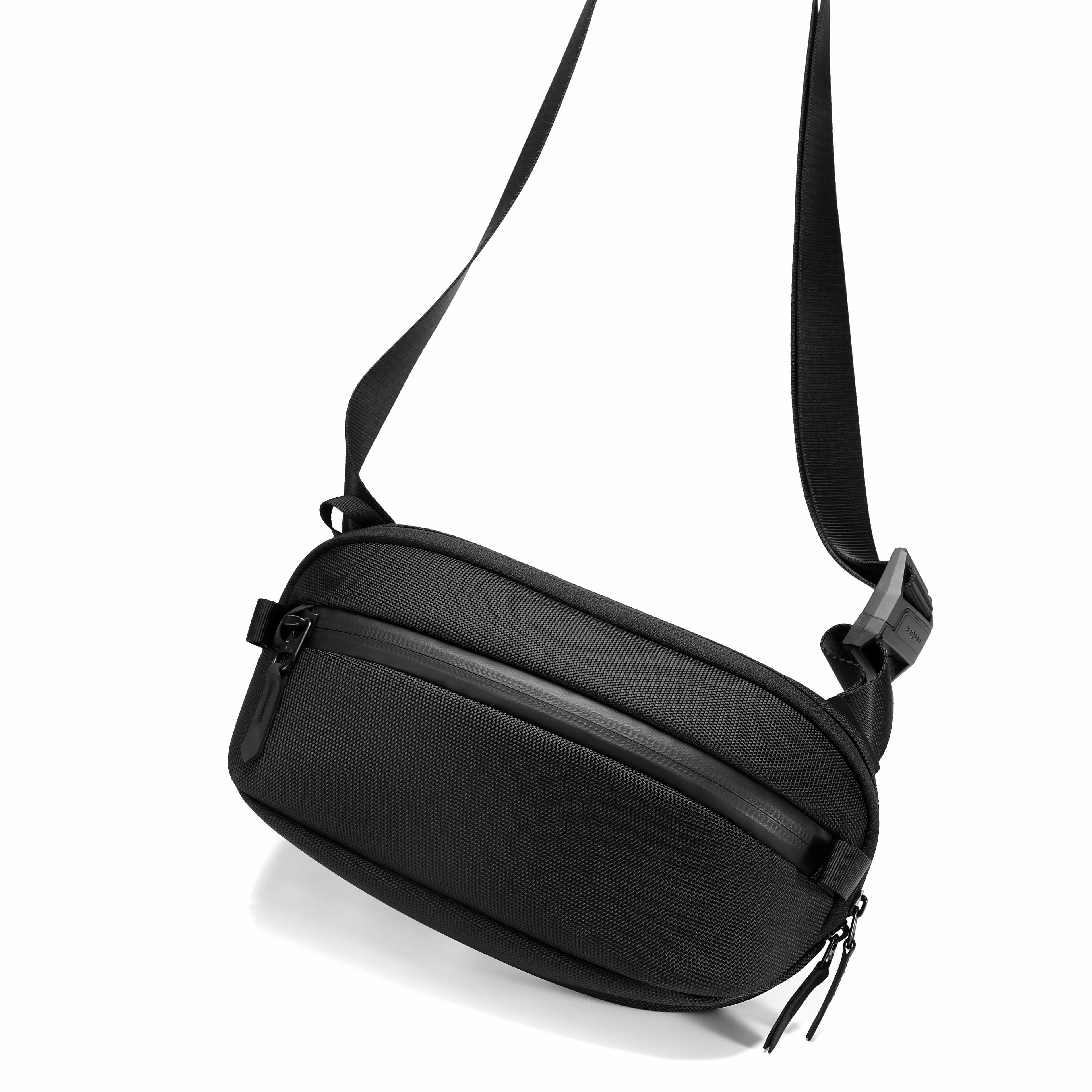 Black shoulder bag with a strap on a white background