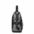 A gray and black sling backpack with a front utility pocket and adjustable shoulder strap, shown against a plain white background.