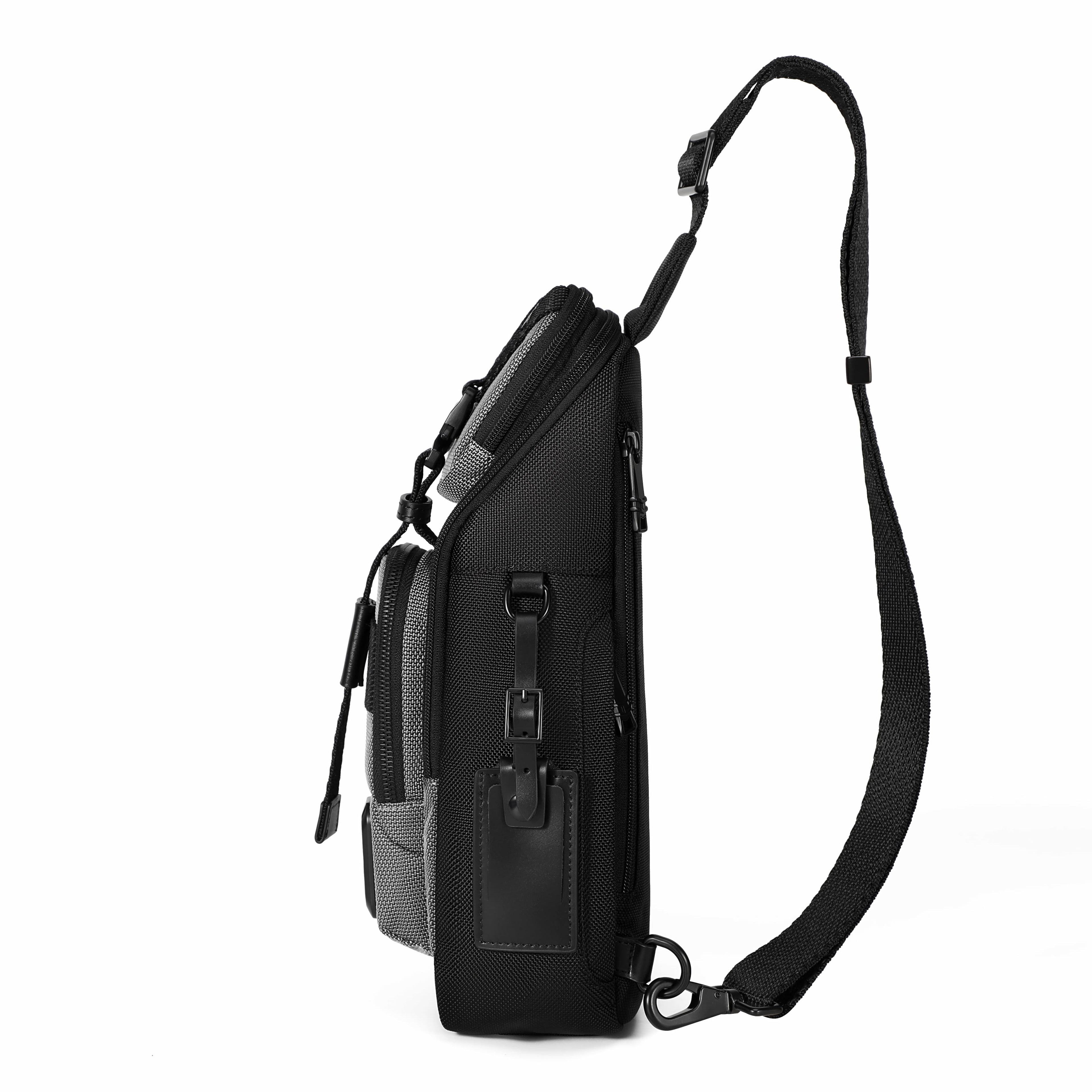 A black sling backpack shown from the side profile against a solid white background, featuring a single adjustable shoulder strap and multiple zippered compartments.