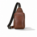 A brown leather crossbody sling bag with a black adjustable strap and silver-tone hardware, shown on a clean white background.
