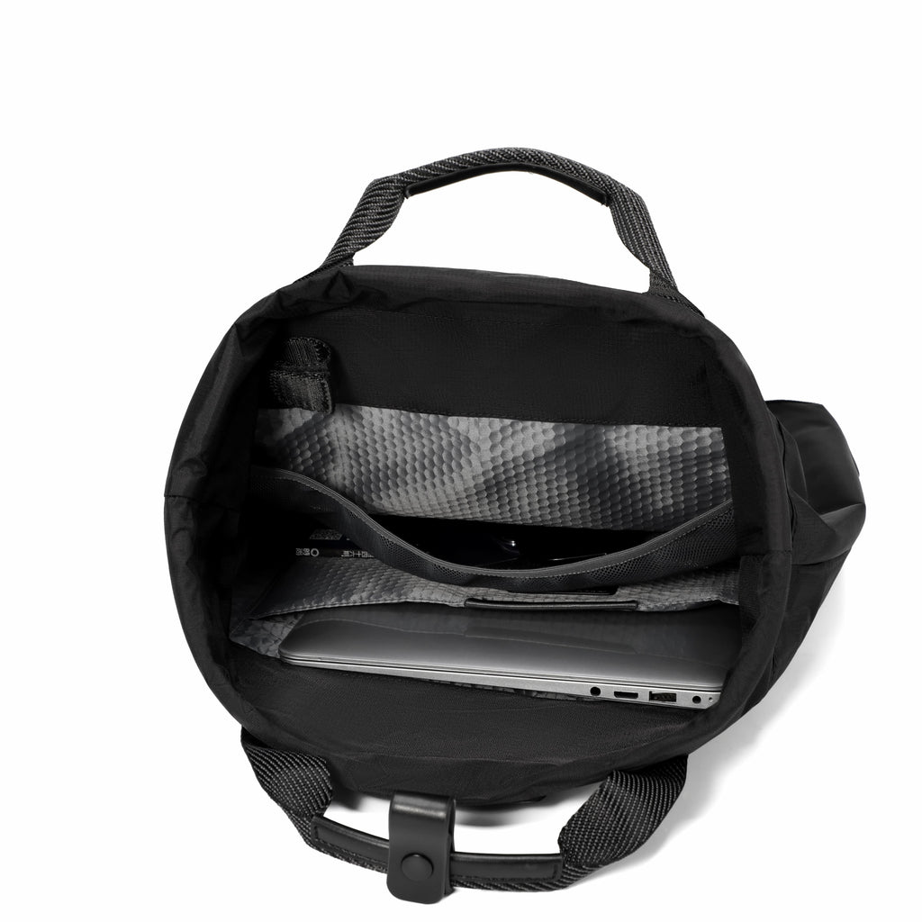 Black backpack shown open from above, revealing interior compartments, a laptop inside, and a black handle on a plain white background.