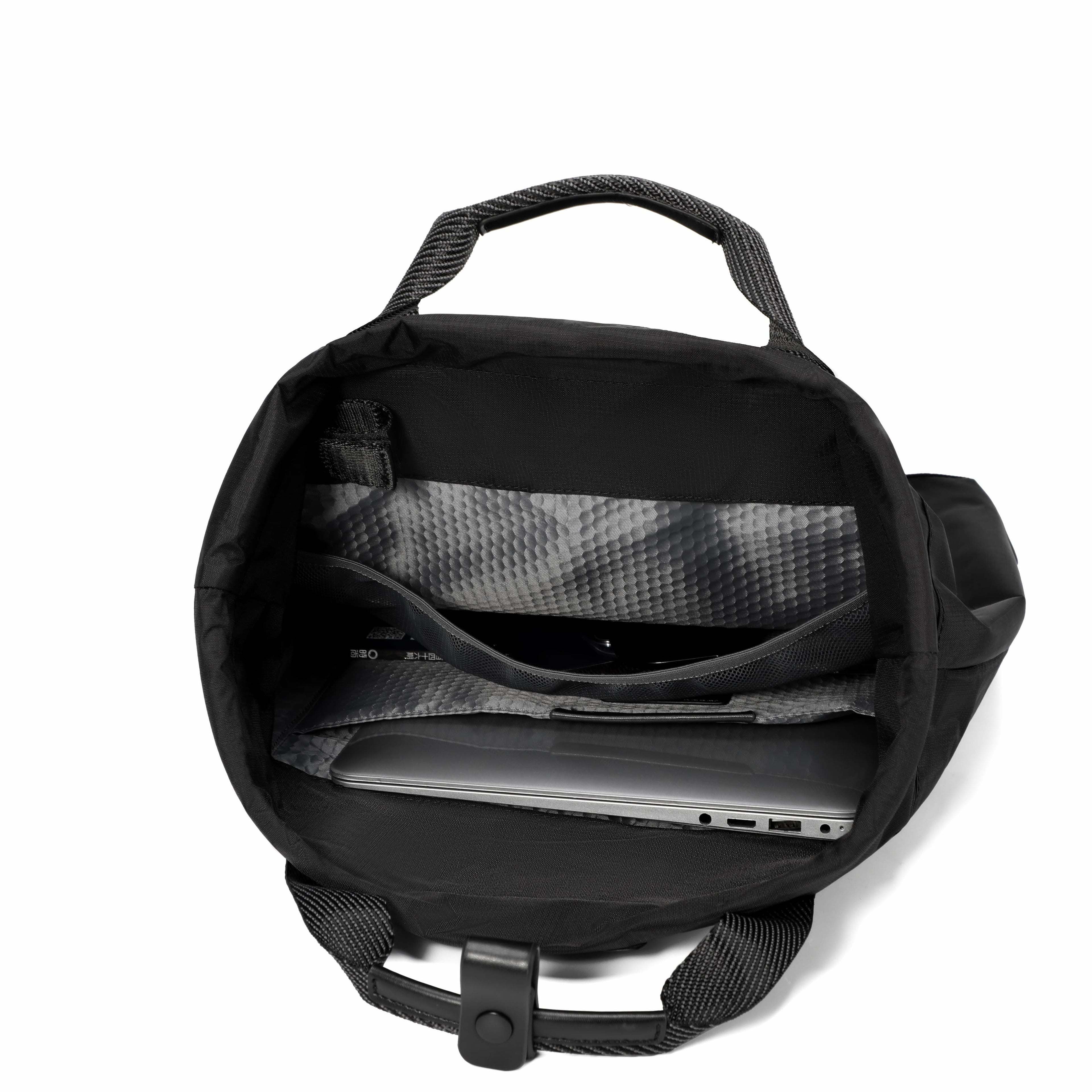 Black backpack shown open from above, revealing interior compartments, a laptop inside, and a black handle on a plain white background.