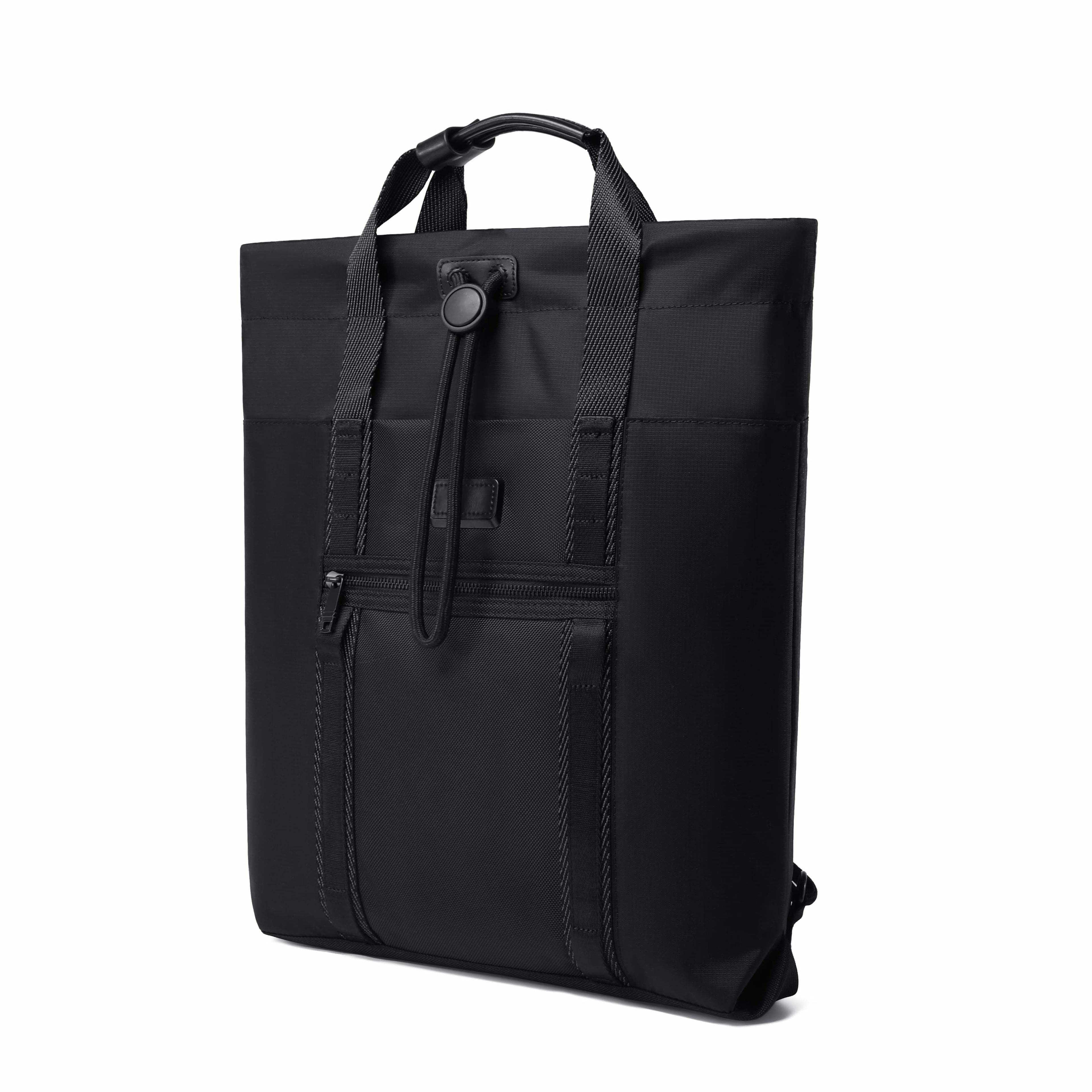 A black nylon tote bag with dual top handles, a front zippered pocket, and a vertical front strap closure, shown from a three-quarter angle on a white background.